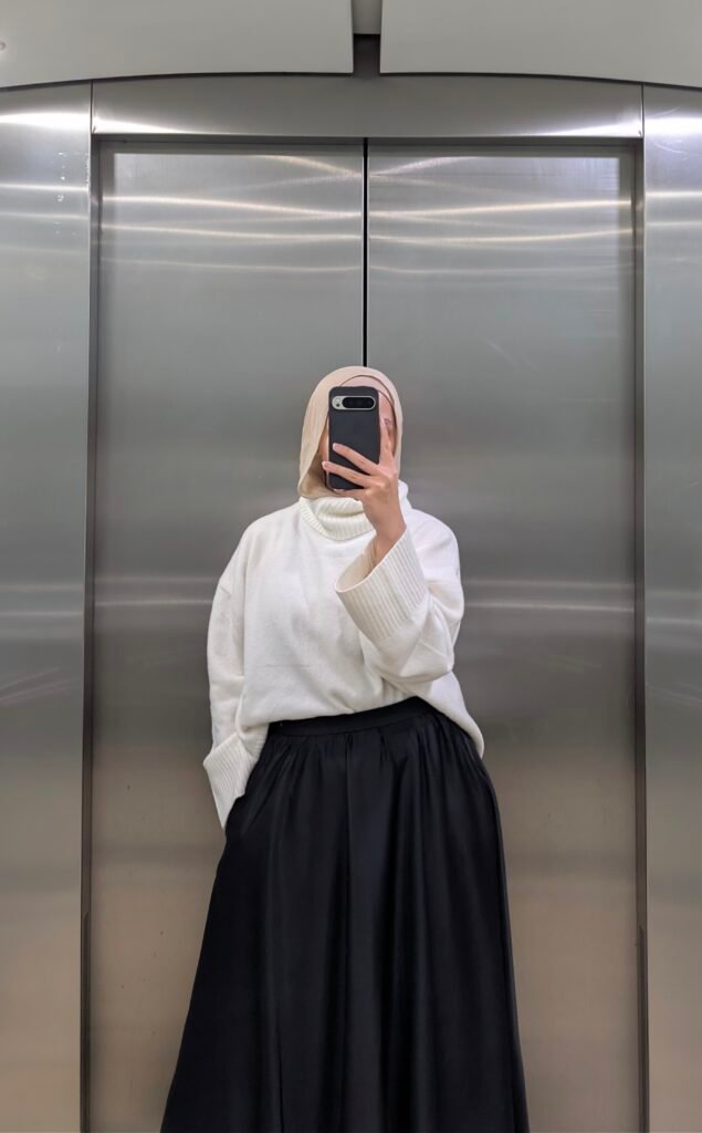white jumper black silk skirt elevator pic
